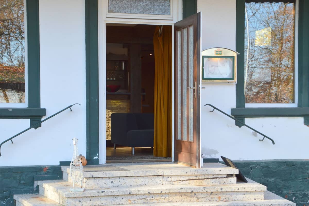 A building entrance with a set of stone steps leading up to a door.