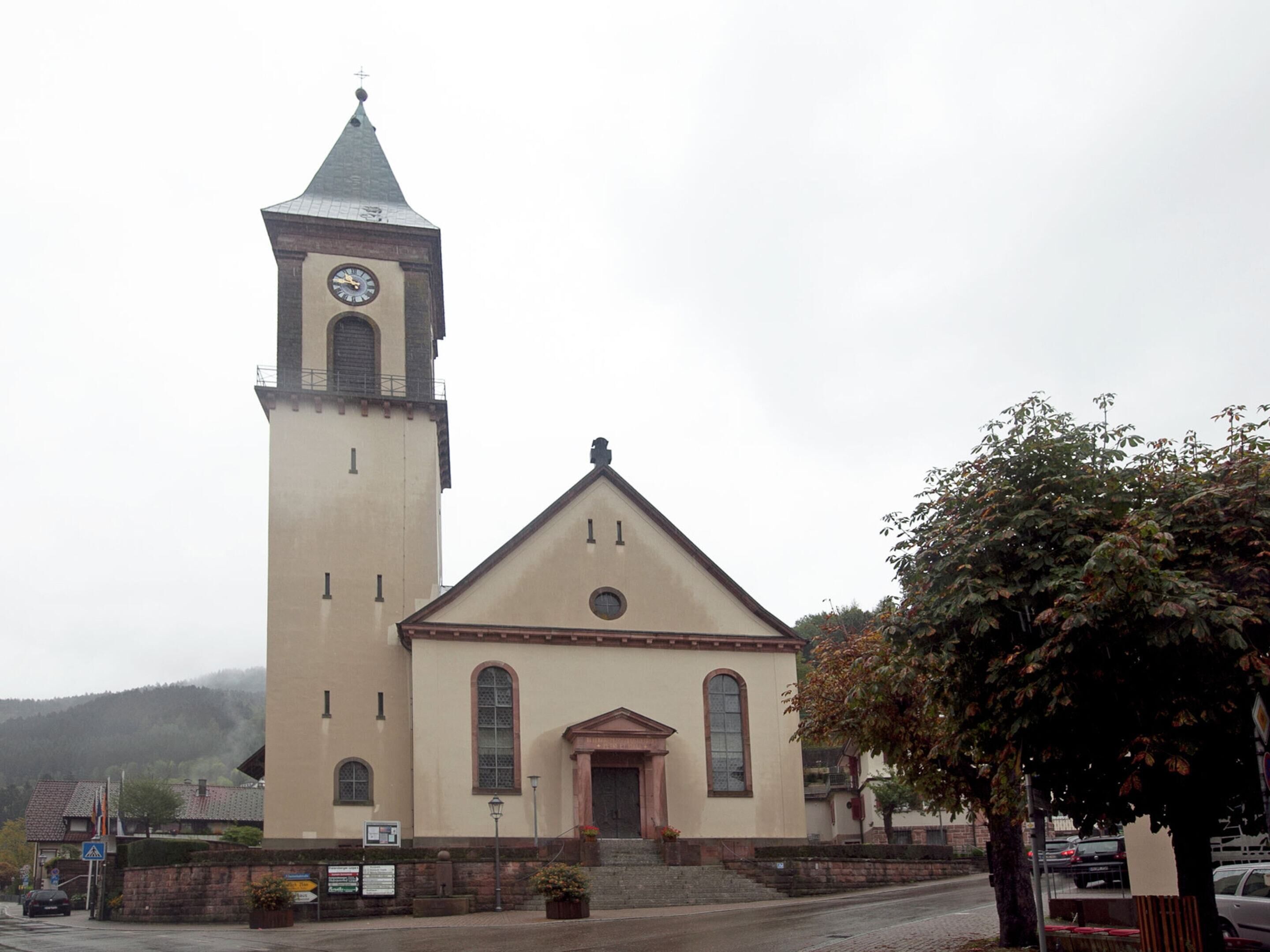 A church with a bell tower and a main building.