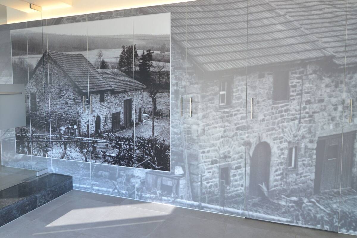 A modern interior with a large wall-mounted display of a stone building.
