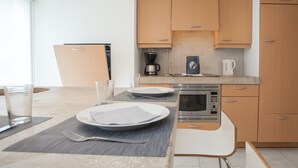 A modern kitchen with wooden cabinets, a built-in oven, and a coffee maker. - Large Apartment in Winterberg-neuastenberg Located Directly on a ski Area (Winterberg)