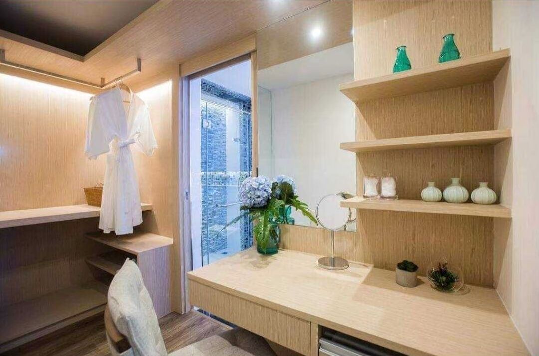 A modern bathroom with a wooden vanity, a mirror, and shelves with decorative items.