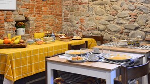 A rustic dining area with brick walls and a yellow checkered tablecloth. - Simplistic Holiday Home in Pistoia With Terrace & Garden (Pistoia)