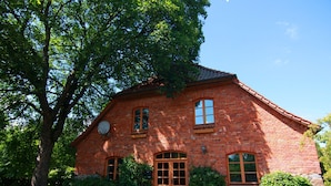 A brick building with a central entrance, large windows, and a sloped roof. - Mansion in Gressow With Terrace, Garden, Bbq, Pond, Bicycles (Gaegelow)