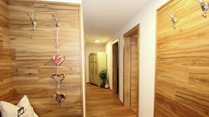 A hallway with wooden walls and a bench with pillows. - Spacious Holiday Home Near Ski Area in Kaltenbach (Kaltenbach)