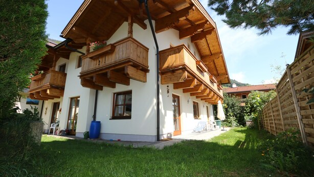 A chalet-style building with wooden balconies and a white facade. - Apartment in Bramberg am Wildkogel With Parking Space (Bramberg am Wildkogel)