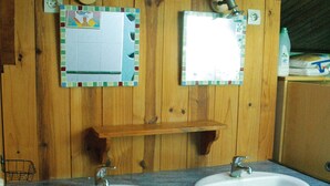 A bathroom with two sinks, wooden walls, and a mirror above each sink. - Room for 2 or 3 people (Chemillé-en-Anjou)