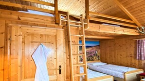 A wooden cabin with two single beds, a ladder, and a door with a towel hanging. - Holiday Home in Gaal im Murtal in a Beautiful Setting (Gaal)