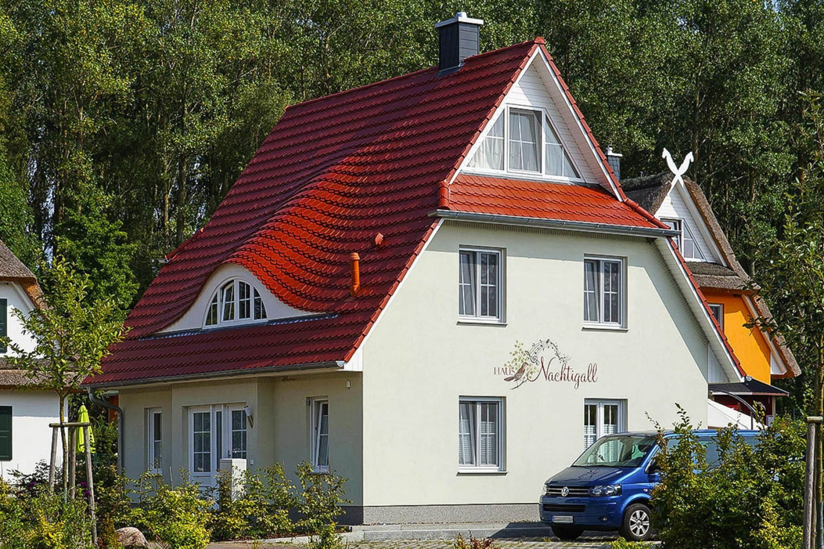 A two-story building with a red-tiled roof and a sign that reads "Hotel Nachtigall."