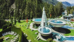 A resort with multiple swimming pools, a central tower, and a mountainous backdrop. - Terraced Houses Oliver, Langenfeld (Laengenfeld)