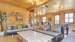 A cozy cabin interior with a wooden interior, a sofa set, a coffee table, and a foosball table. - Detached Wooden Chalet in Liebenfels / Carinthia Near the Simonhohe ski Area (Liebenfels)