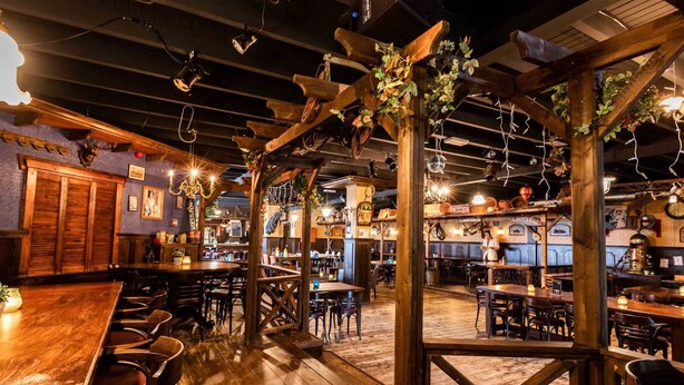 A rustic bar area with wooden furniture and exposed beams. - Luxury Chalet With Dishwasher, in a Holiday Park in the Middle of De Veluwe (Ede)