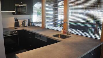 Comfort Chalet, 4 Bedrooms | Private kitchen | Microwave, oven, dishwasher
