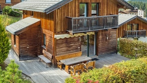 A wooden cabin with a balcony, a deck, and a large window. - Chalet in Annaberg-lungotz With a Community Pool (Annaberg-Lungoetz)