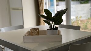 A white table with a potted plant and a wicker basket. - Neat Chalet With Microwave, Antwerp at 39 km (Rijkevorsel)