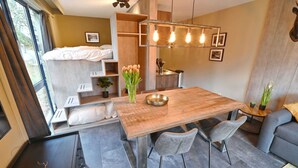 A modern, compact living space with a dining area, kitchenette, and a bed. - Modern Suite With Combi-microwave, Close to Durbuy (Durbuy)