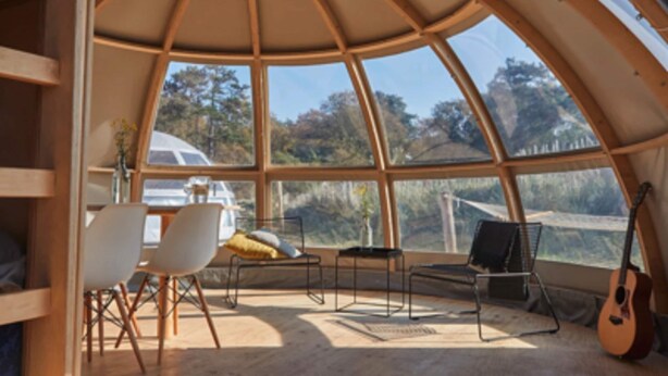 A cozy, dome-shaped room with a large window offering a scenic view of trees and a car outside. - Wellness Lodge With Sauna and Wonderful Views (Zuna)