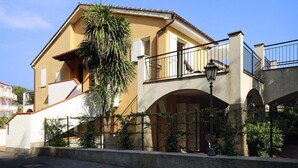 A two-story building with a balcony, a staircase, and a street lamp. - Apartment in San Bartolomeo Al Mare (San Bartolomeo al Mare)