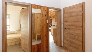 A modern interior with wooden doors leading to a bedroom and a living area. - Family Holiday Home in Kleinarl With Terrace (Kleinarl)