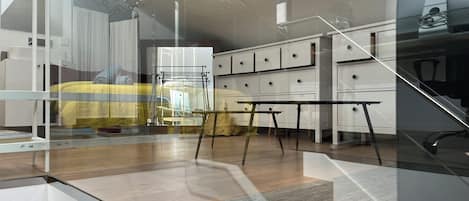 A modern bedroom with a bunk bed, a desk, and a chair.