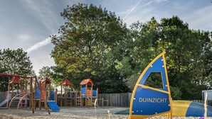 A playground with a sandy surface and a sail-shaped play structure labeled "DUINZICHT". - Comfortable Chalet With Microwave, on a Holiday Park 1 km. From the Beach (Koudekerke)