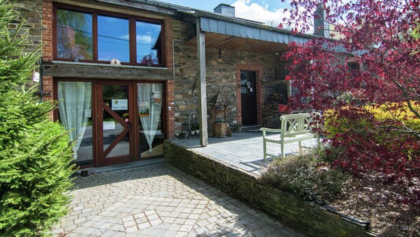 A stone building with a wooden deck and a bench. - Tranquil Apartment in Sensenruth With Barbecue (Bouillon)