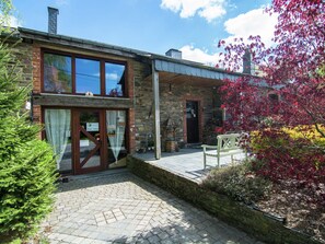 A stone building with a wooden deck and a bench. - Tranquil Apartment in Sensenruth With Barbecue (Bouillon)
