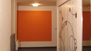 A hallway with a tiled floor, a white bench, and a door with a decorative design. - Attractive Apartment in Rokytnice nad Jizerou Near Ski Area (Rokytnice nad Jizerou)