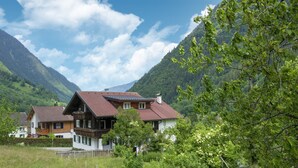 A chalet-style house with a sloped roof, wooden balconies, and a view of a mountainous landscape. - Holiday Home Near ski Resort in St. Gallenkirch (Sankt Gallenkirch)