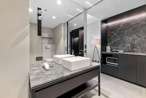 A modern bathroom with a large mirror, two sinks, a vanity, and a marble countertop. - Clarion Apartments South Melbourne (Melbourne)