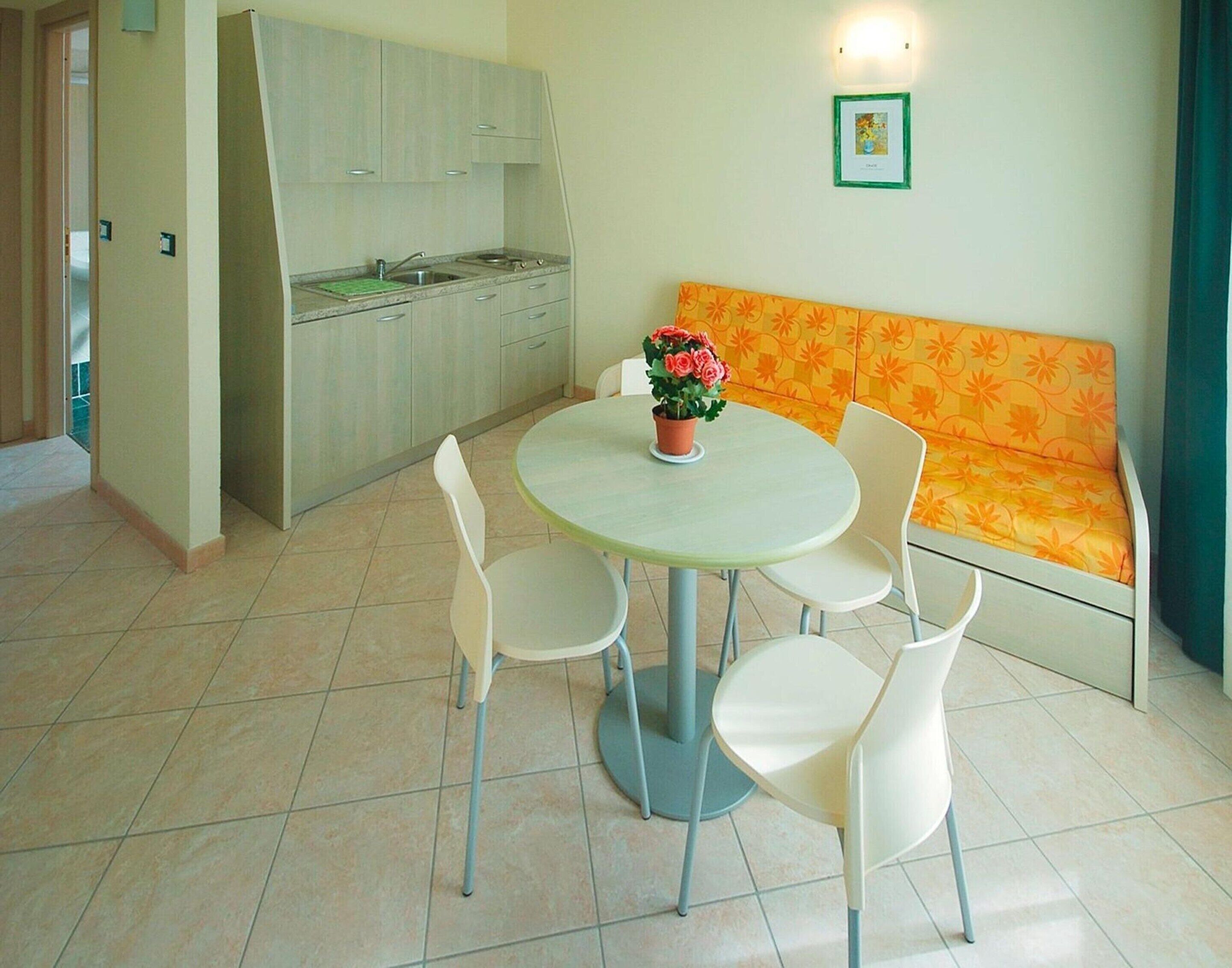 A compact living space with a kitchen, dining area, and a sofa.