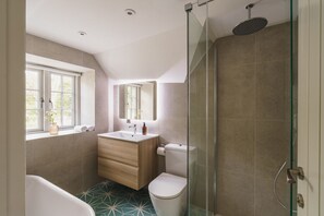 Bathroom features a bathtub, glass-enclosed shower, and standard toilet.