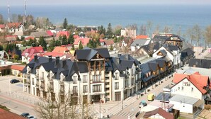 A coastal town with a prominent building labeled "MUSEUM PUSKINA" and a view of the sea. - Cozy Holiday Homes Near the Beach in Jaroslawiec (Postomino)