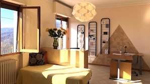 A room with a bed, a desk, a radiator, a window with a view, a vase with flowers, and a decorative light fixture. - Spectacular Holiday Home in Pescia With Swimming Pool (Pescia)