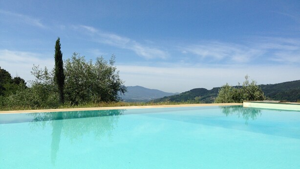 A clear blue swimming pool with a view of distant hills and trees. - Spectacular Holiday Home in Pescia With Swimming Pool (Pescia)