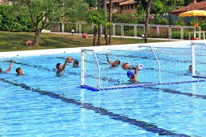 A swimming pool with a goalpost, water polo players, and a net. - Apartments Poiano in Garda With Pool (Garda)