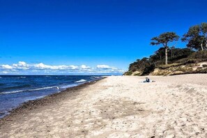 A beach with clear skies, a sandy shore, and a few trees. - Cozy Cottage for 2 People Near the Sandy Beach (gmina Bedzino)