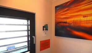 Enjoy a room with a balcony, framed artwork, and convenient amenities.