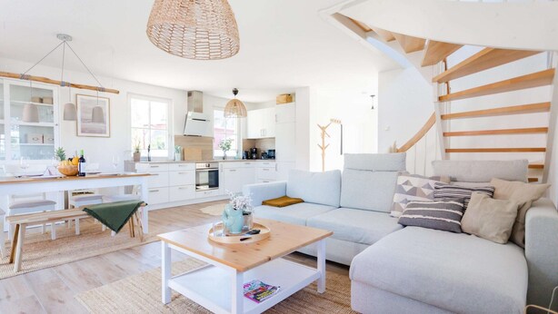 A modern living room with a sofa, coffee table, and dining area. - Holiday Home With Sauna in Boiensdorf (Boiensdorf)