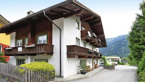 A traditional chalet with wooden balconies, a white facade, and a mountain backdrop. - Holiday Home Bergheim, Fugen (Fuegen)
