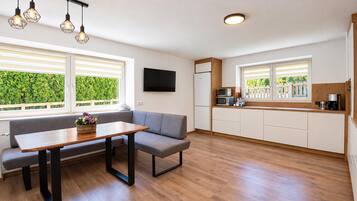 A modern kitchen with a built-in oven, microwave, and coffee maker.