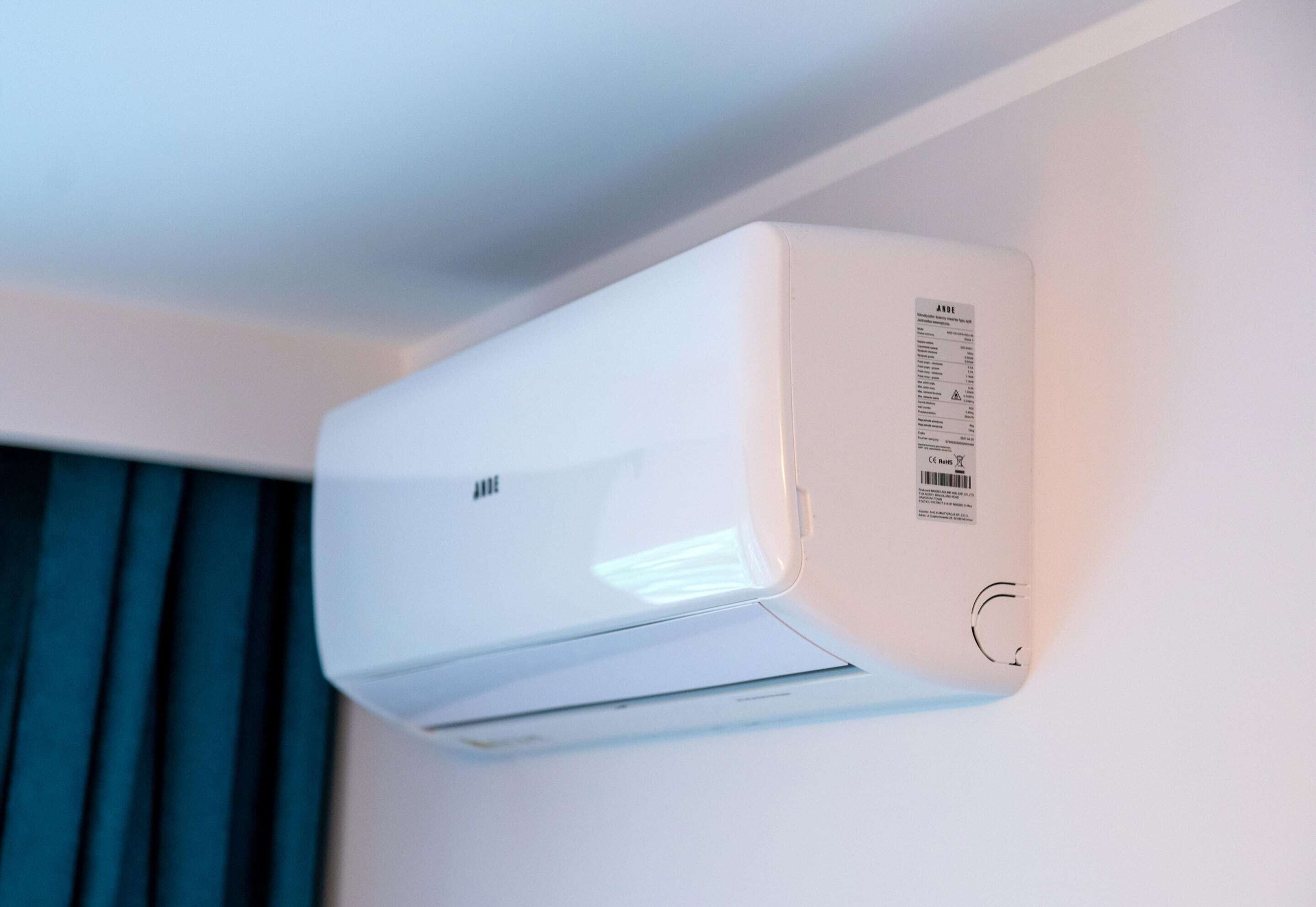 A white air conditioning unit mounted on a wall.