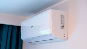 A white air conditioning unit mounted on a wall.