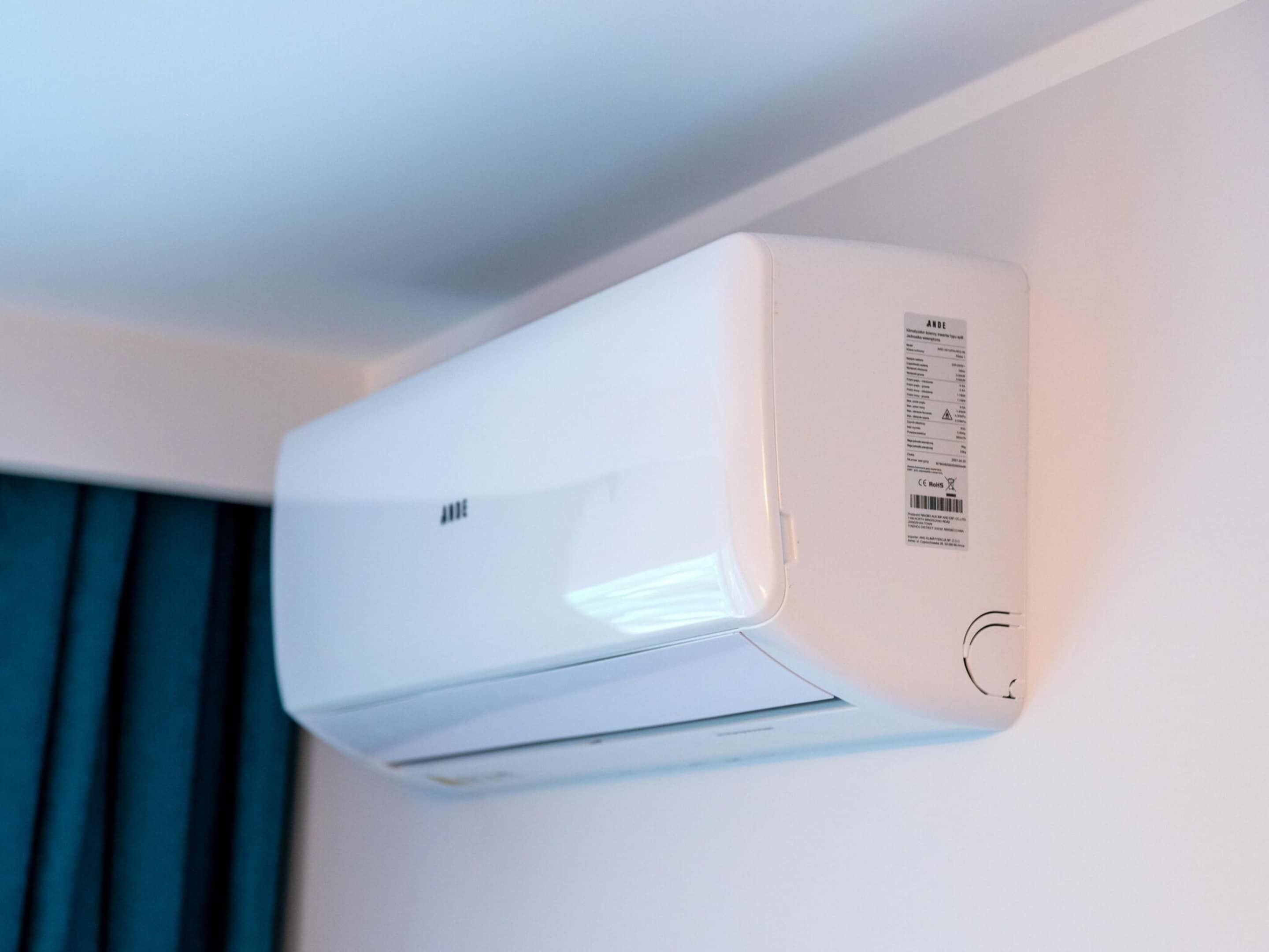 A white air conditioning unit mounted on a wall.