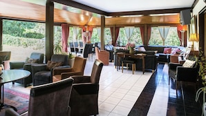 A spacious indoor area with multiple seating arrangements, including sofas and chairs, and a dining table. - Atmospheric Holiday Home in Durbuy With Sauna (Durbuy)