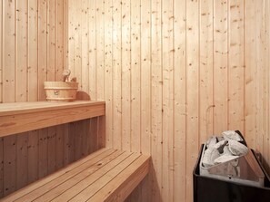 A wooden sauna with benches and a trash bin. - 8 Person Holiday Home in Hasle (Hasle)