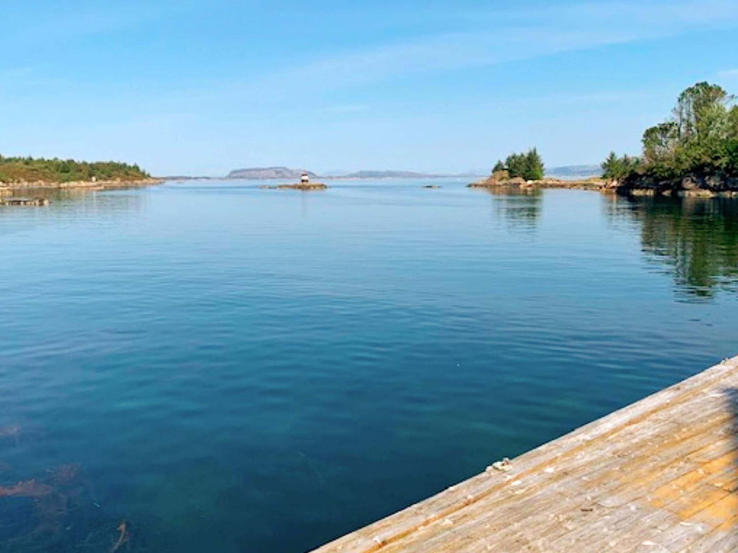 A calm lake with a wooden dock extending into the water.