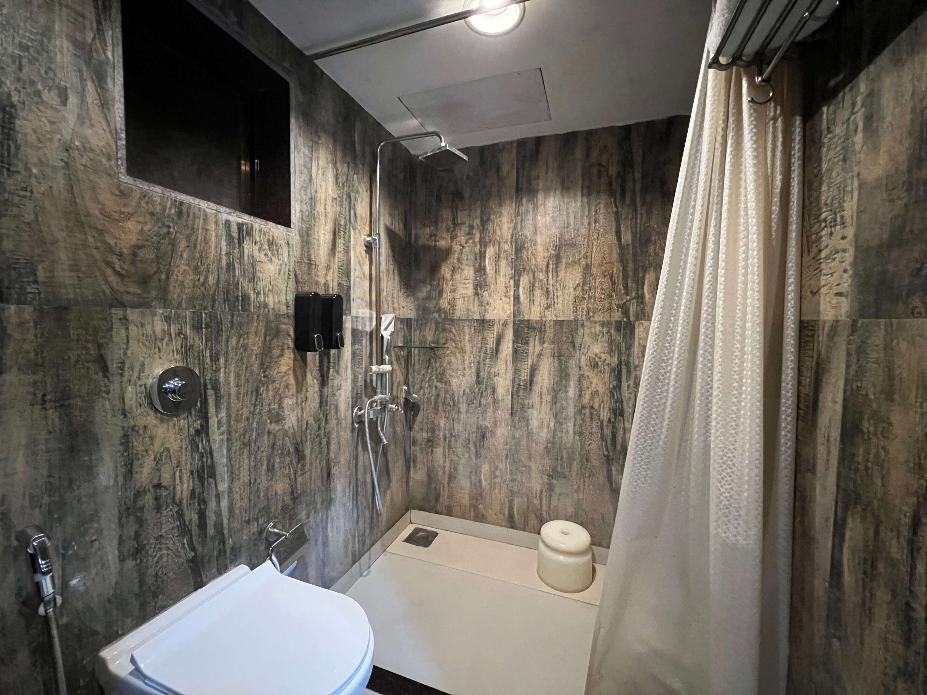 A bathroom with a shower, toilet, and sink.