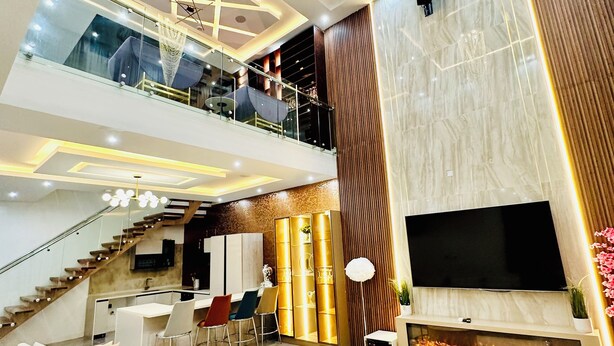 A modern living area with a sofa, TV, and a fireplace. - Lekki Villas (Lekki)
