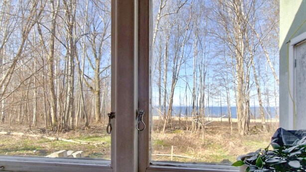A window with a view of leafless trees and a distant body of water. - 4 Person Holiday Home in Granna (Gränna)