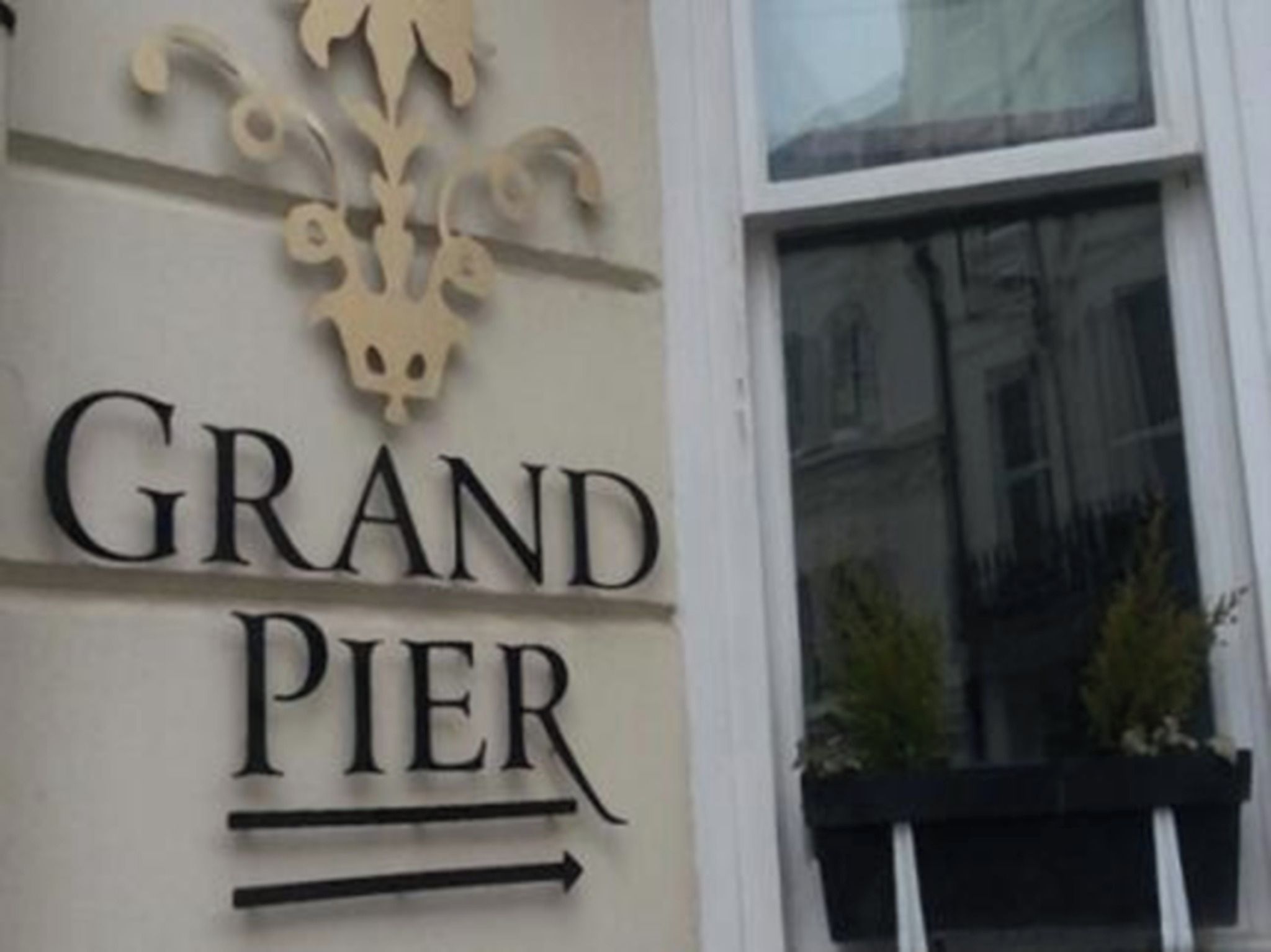 A building facade with the sign 'GRAND PIER' indicating the name of the establishment.